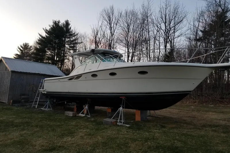Slide: The Image of 1998 Tiara Yachts 3500 Open on stands, surrounded by trees and a shed. - 11