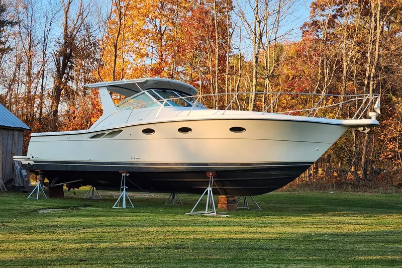 Slide: The Image of 1998 Tiara Yachts 3500 Open on stands, surrounded by autumn trees. - 14
