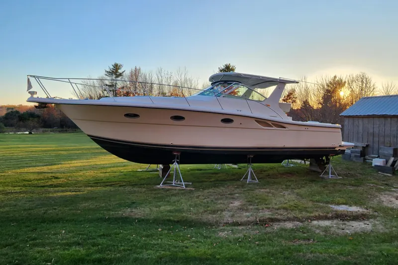 Slide: The Image of 1998 Tiara Yachts 3500 Open on stands, sunset backdrop, grassy area. - 16