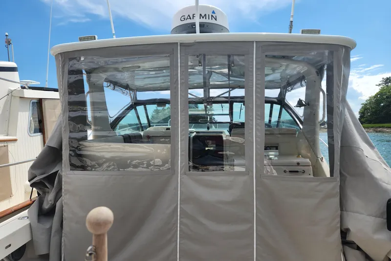 Slide: The Image of 1998 Tiara Yachts 3500 Open with covered cockpit, docked under clear blue skies. - 19