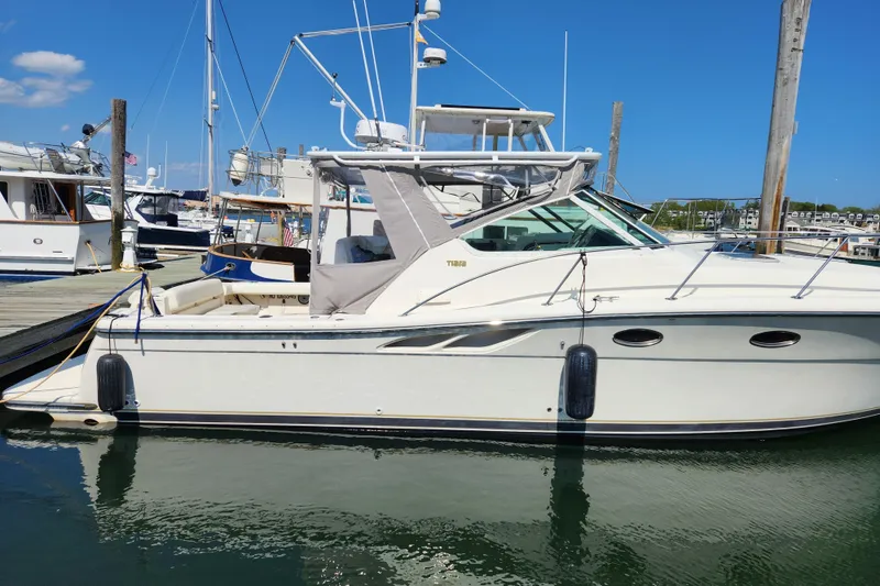 Slide: The Image of 1998 Tiara Yachts 3500 Open docked at marina under clear blue sky. - 2