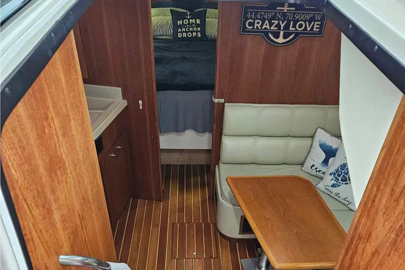 Slide: The Image of 1998 Tiara Yachts 3500 Open interior with wood finish and cozy seating area. - 20