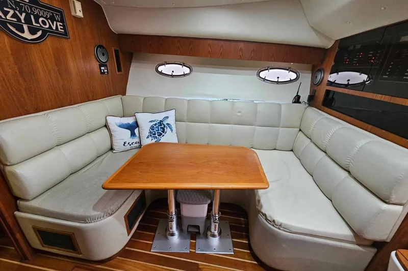 Slide: The Image of 1998 Tiara Yachts 3500 Open interior with cozy seating and wooden table. - 21
