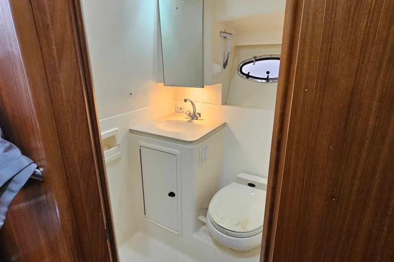 Slide: The Image of Bathroom interior of 1998 Tiara Yachts 3500 Open, featuring sink and toilet. - 25