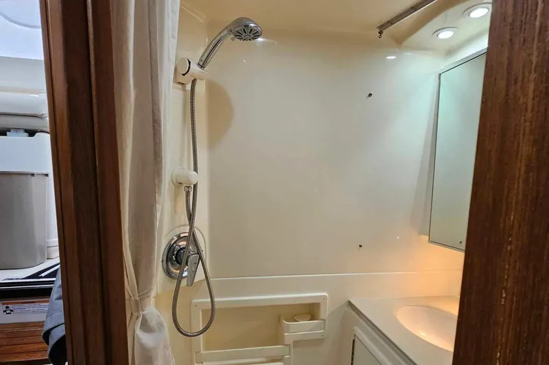 Slide: The Image of Bathroom interior of 1998 Tiara Yachts 3500 Open with shower and sink. - 26