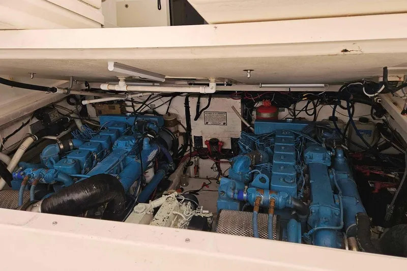 Slide: The Image of Engine room of a 1998 Tiara Yachts 3500 Open, showcasing dual blue engines. - 29