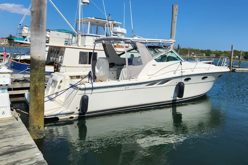 Slide: The Image of 1998 Tiara Yachts 3500 Open docked at marina on a sunny day. - 3