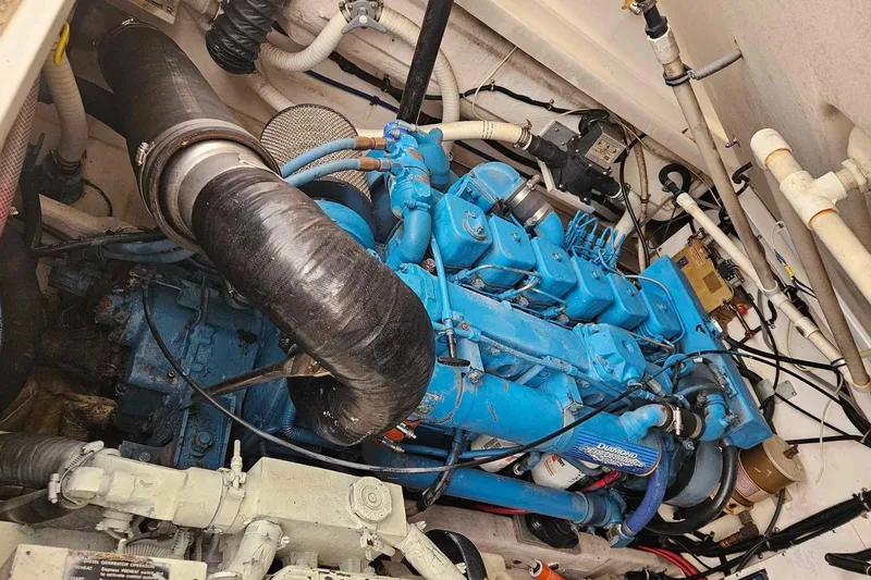 Slide: The Image of Engine compartment of a 1998 Tiara Yachts 3500 Open, featuring a blue marine engine. - 30