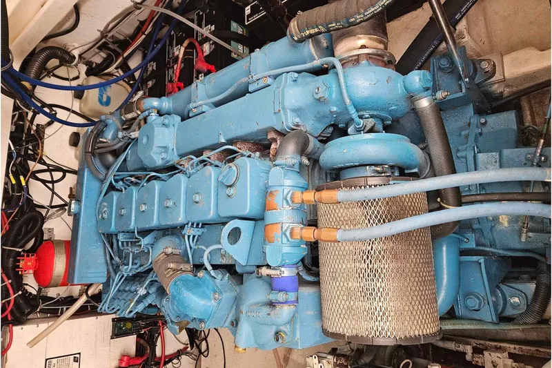 Slide: The Image of Engine compartment of a 1998 Tiara Yachts 3500 Open, featuring a blue marine engine. - 31