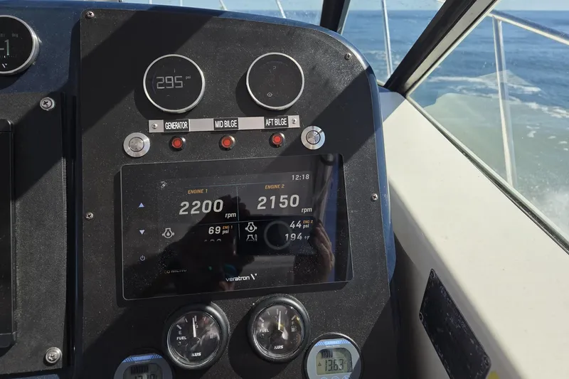 Slide: The Image of Dashboard of a 1998 Tiara Yachts 3500 Open, displaying engine RPM and pressure. - 35