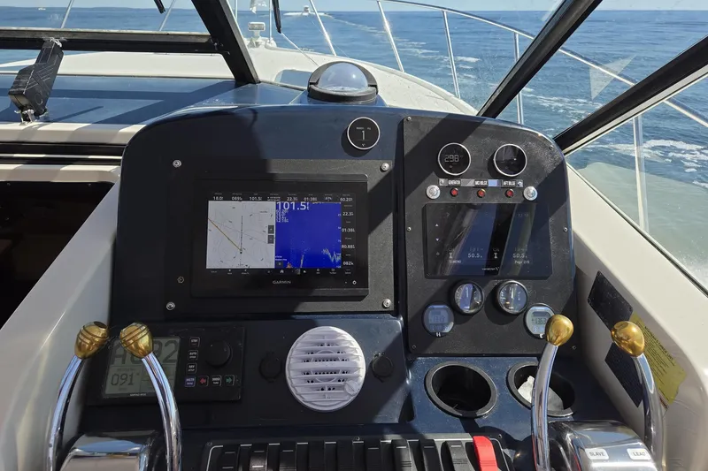 Slide: The Image of 1998 Tiara Yachts 3500 Open helm with navigation and control instruments. - 36