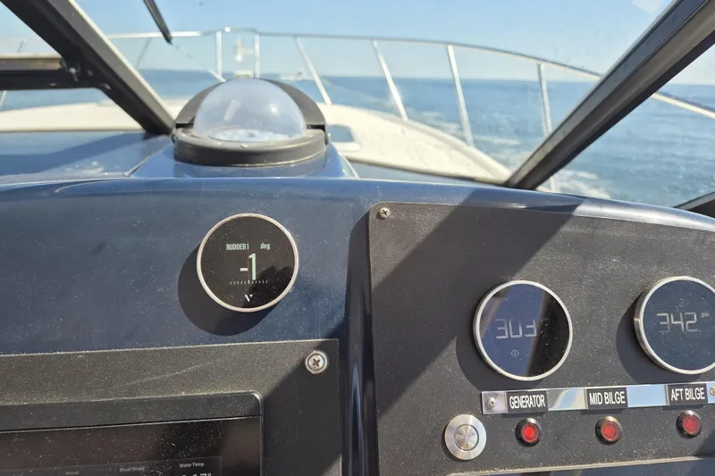 Slide: The Image of Dashboard view of a 1998 Tiara Yachts 3500 Open, showing navigation instruments at sea. - 37