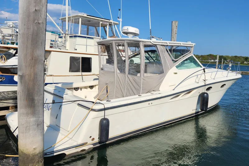 Slide: The Image of 1998 Tiara Yachts 3500 Open docked in a marina under clear blue skies. - 5