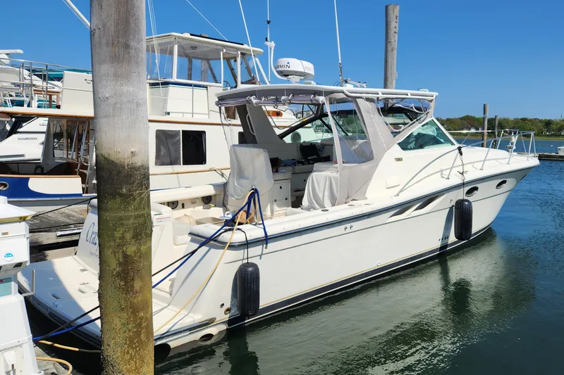 Slide: The Image of 1998 Tiara Yachts 3500 Open docked in a marina under clear blue skies. - 6