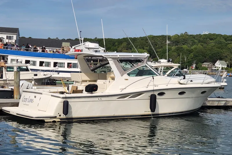 Slide: The Image of 1998 Tiara Yachts 3500 Open docked in a scenic marina setting. - 7