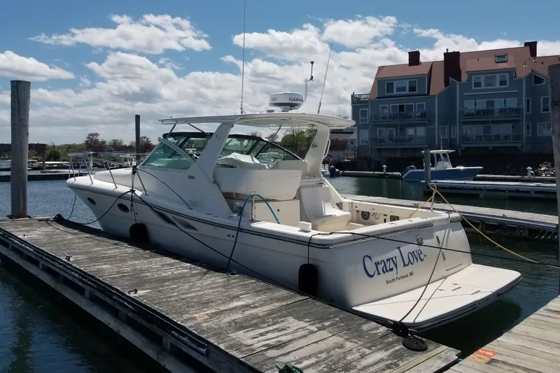 Slide: The Image of 1998 Tiara Yachts 3500 Open docked, named "Crazy Love," in a marina setting. - 8