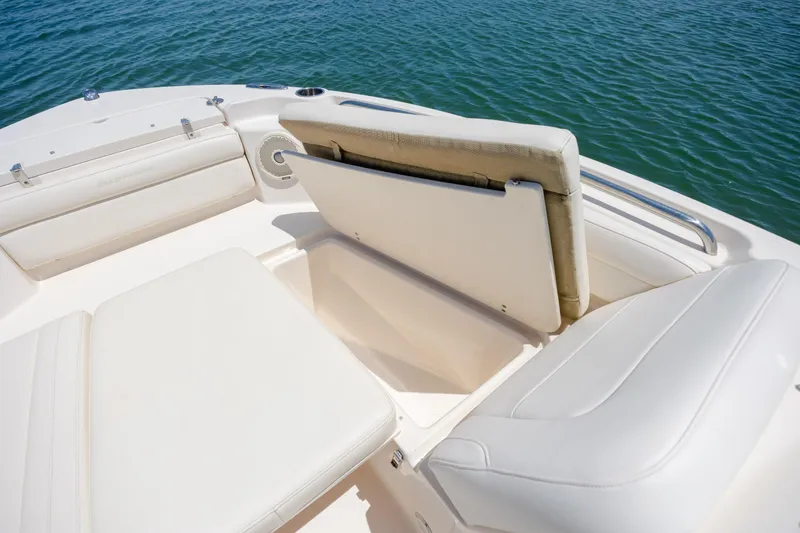 Slide: The Image of 2019 Grady-White Freedom 215 boat interior with cushioned seating and storage compartment. - 10