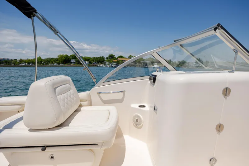 Slide: The Image of 2019 Grady-White Freedom 215 boat interior with white seating and clear skies. - 12