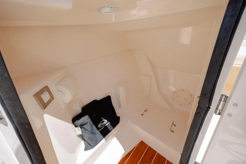 Slide: The Image of Interior of 2019 Grady-White Freedom 215 boat, featuring storage space and wooden flooring. - 15