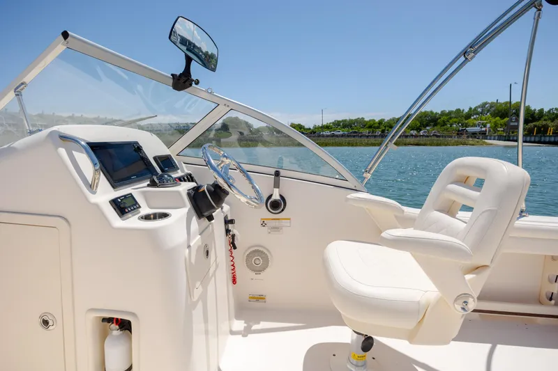 Slide: The Image of 2019 Grady-White Freedom 215 boat interior with steering wheel and captain's chair. - 16