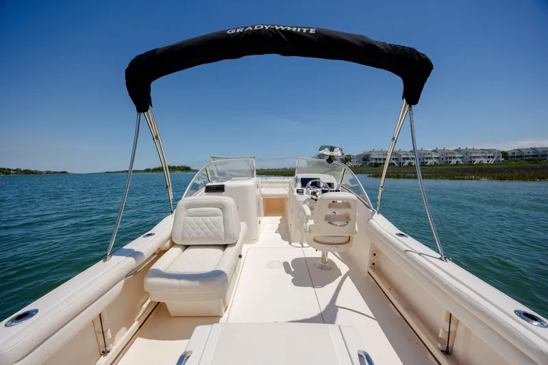 Slide: The Image of 2019 Grady-White Freedom 215 boat on calm water with clear blue sky. - 26