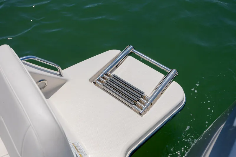 Slide: The Image of 2019 Grady-White Freedom 215 boat swim platform with folded ladder on water. - 29