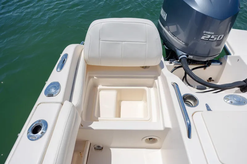 Slide: The Image of 2019 Grady-White Freedom 215 boat interior with Yamaha 250 engine, featuring seating and storage. - 30