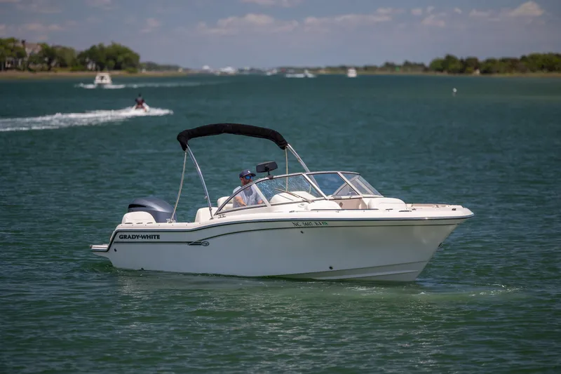 Slide: The Image of 2019 Grady-White Freedom 215 boat cruising on a sunny lake. - 5