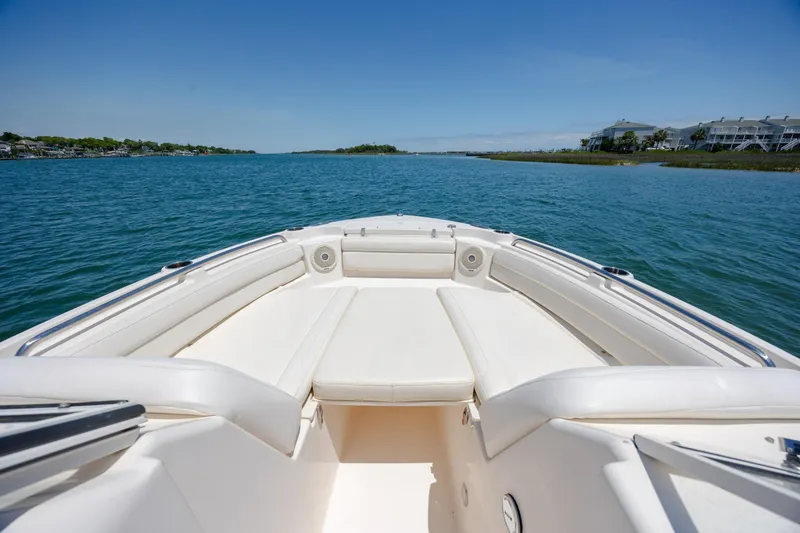 Slide: The Image of 2019 Grady-White Freedom 215 boat on serene blue water, clear sky background. - 7