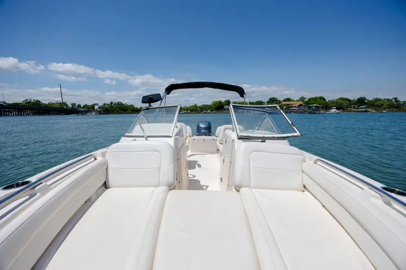 Slide: The Image of 2019 Grady-White Freedom 215 boat on calm water under clear blue sky. - 8