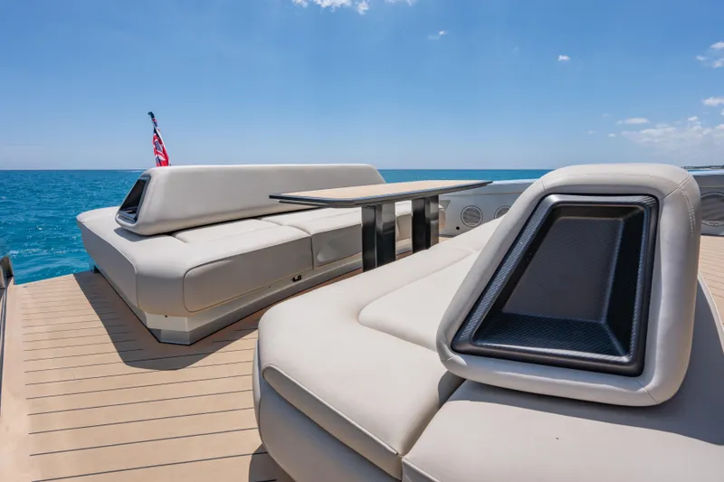 Slide: The Image of Luxurious Wajer 77 yacht deck with plush seating, ocean view, and clear blue sky. - 14