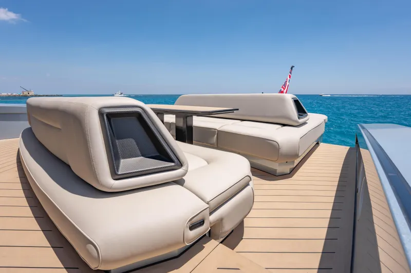 Slide: The Image of Luxurious Wajer 77 yacht deck with modern seating, overlooking serene ocean waters. - 15