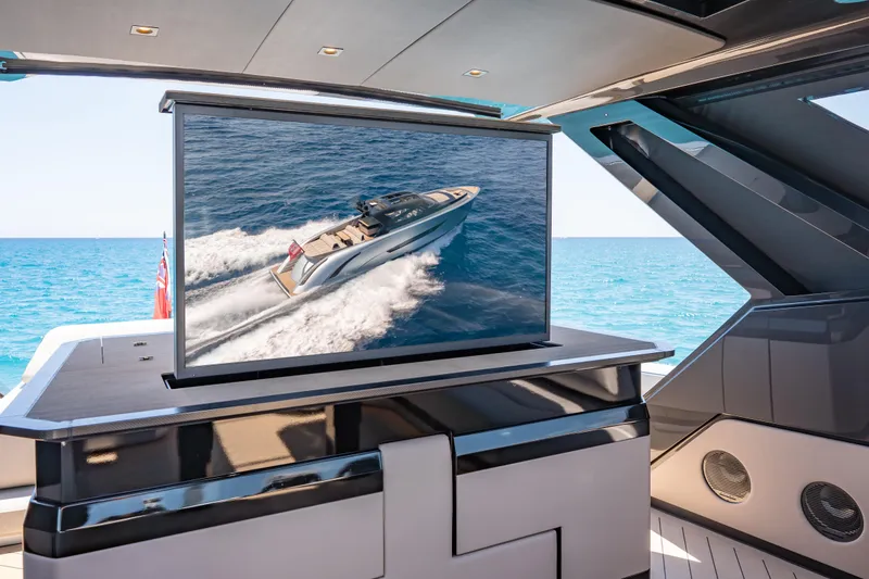 Slide: The Image of Luxury yacht interior with TV displaying Wajer 77 cruising on the ocean. - 23