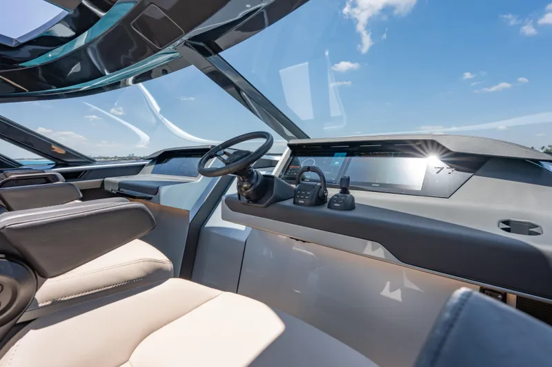 Slide: The Image of Luxurious Wajer 77 yacht cockpit with modern steering and navigation systems under a clear blue sky. - 27