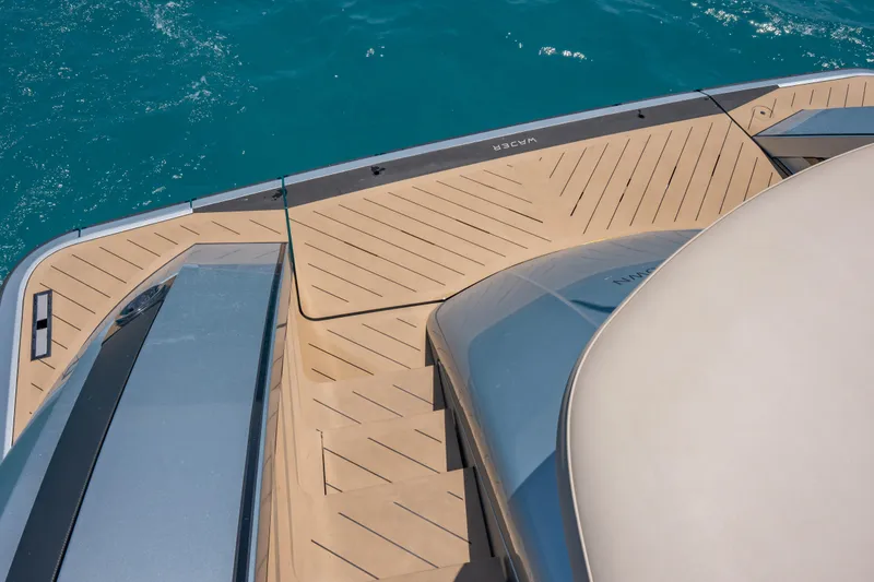 Slide: The Image of Wajer 77 yacht deck with sleek design and turquoise water background. - 35