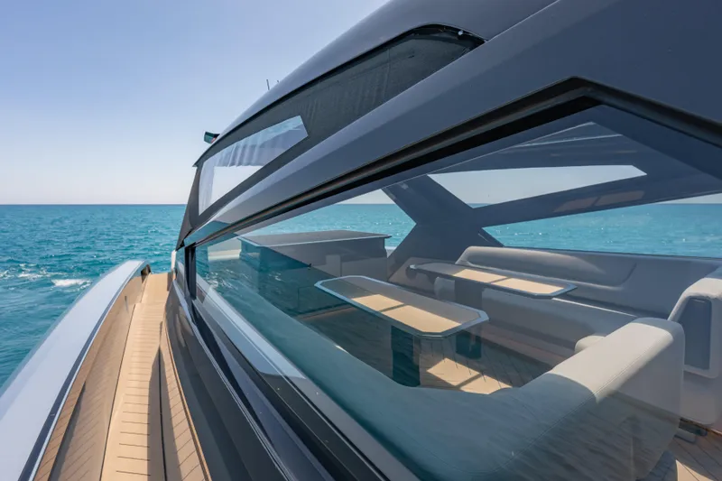 Slide: The Image of Luxurious Wajer 77 yacht cruising on clear blue ocean waters, showcasing sleek design and spacious interior. - 36