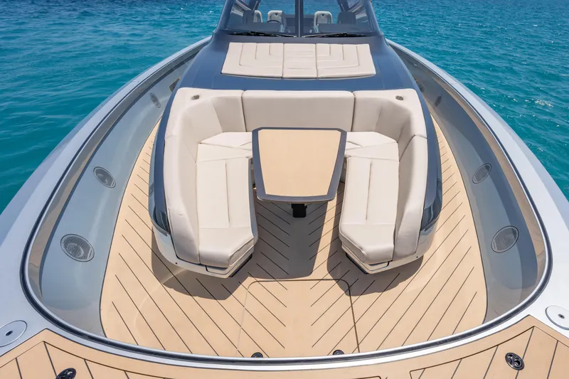 Slide: The Image of Luxurious Wajer 77 yacht deck with elegant seating and table, surrounded by clear blue water. - 37
