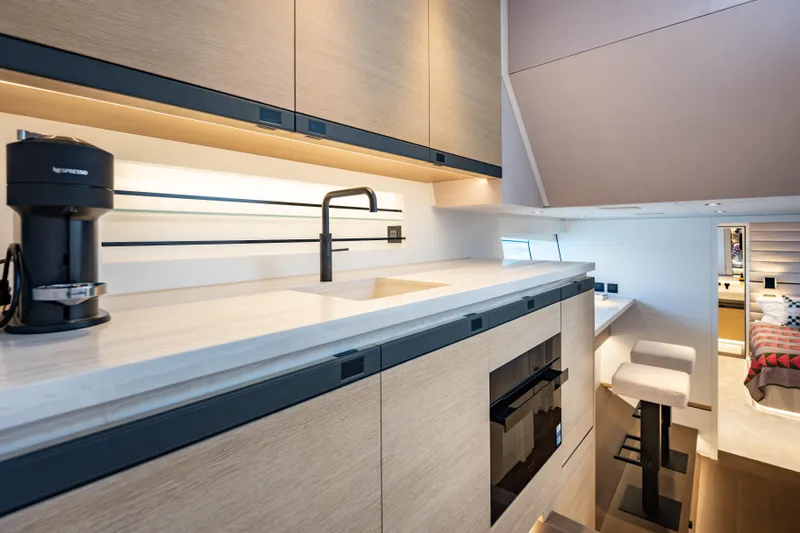 Slide: The Image of Luxurious Wajer 77 yacht interior with modern kitchen and cozy seating area. - 43