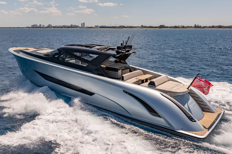 Slide: The Image of Luxury Wajer 77 yacht cruising on open sea with city skyline in background. - 5