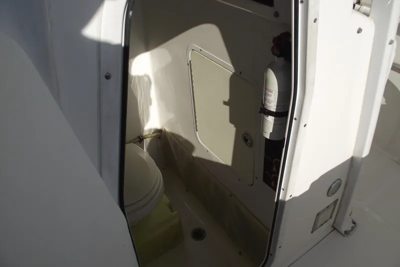 Slide: The Image of Interior view of a 2014 Sea Hunt Gamefish 25 boat's compact restroom area. - 18