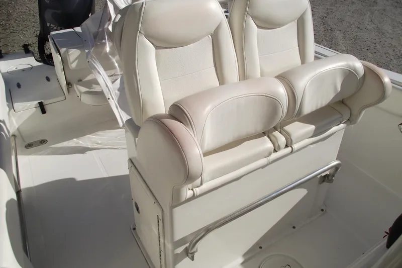 Slide: The Image of 2014 Sea Hunt Gamefish 25 boat interior with white cushioned seating. - 20