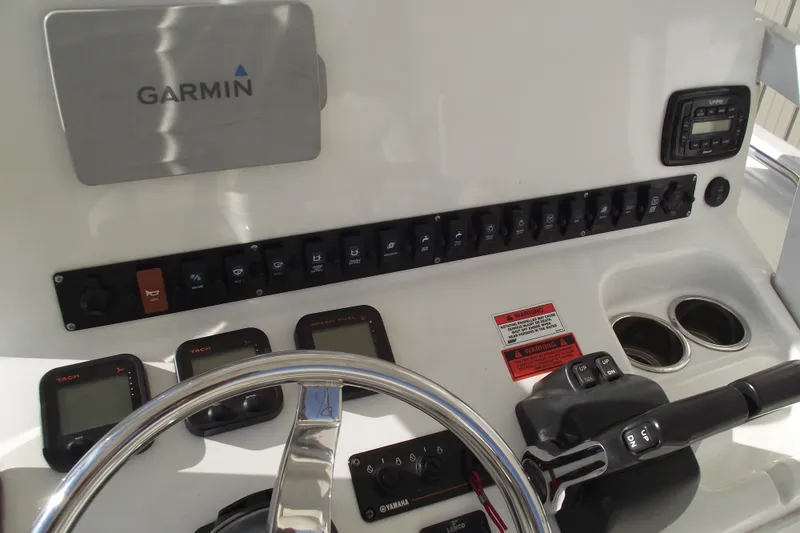 Slide: The Image of 2014 Sea Hunt Gamefish 25 dashboard with Garmin navigation and control panel. - 22