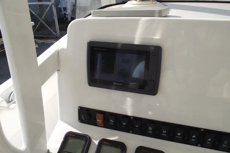 Slide: The Image of 2014 Sea Hunt Gamefish 25 dashboard with Garmin echomap and control panel. - 24