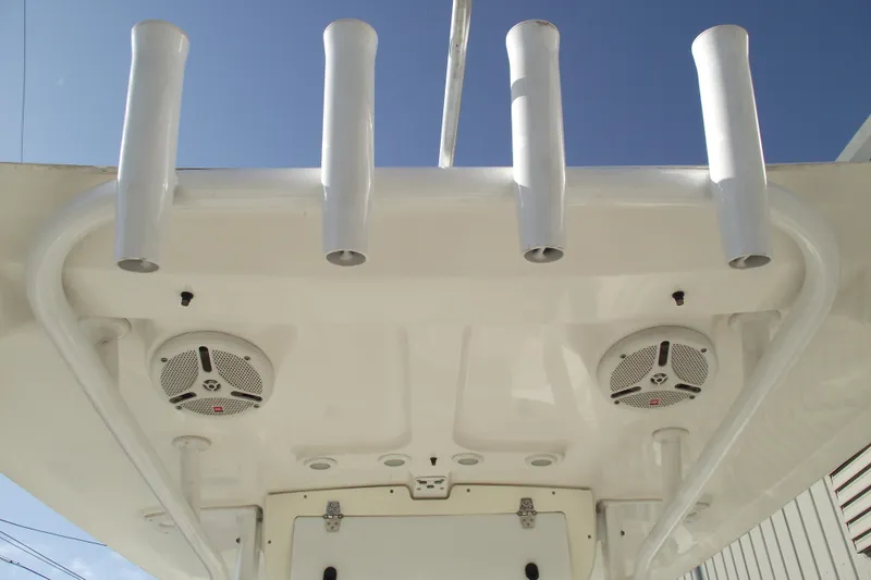Slide: The Image of 2014 Sea Hunt Gamefish 25 boat speakers and rod holders against clear sky. - 26