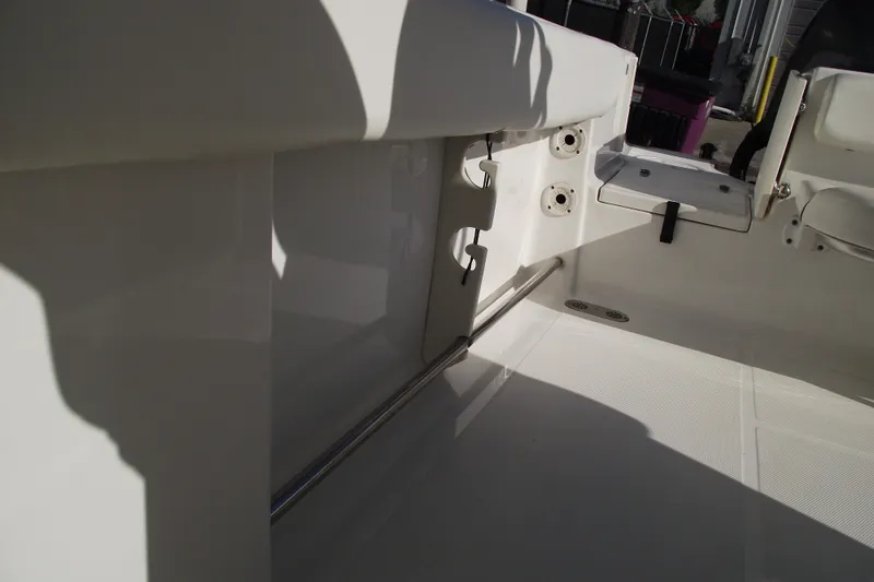 Slide: The Image of Interior view of a 2014 Sea Hunt Gamefish 25 boat, showcasing seating and rod holders. - 28