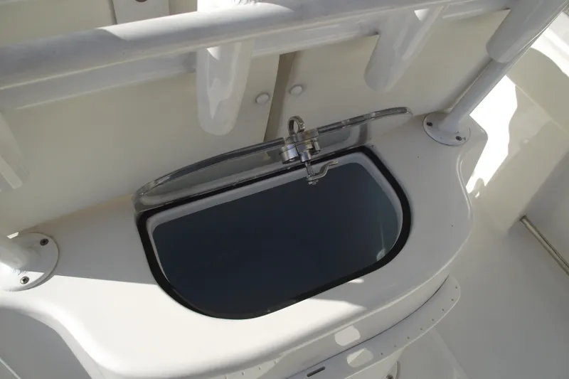Slide: The Image of Livewell on 2014 Sea Hunt Gamefish 25 boat, featuring a sleek design and functional faucet. - 31