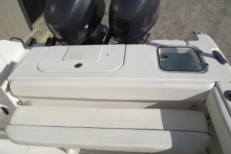 Slide: The Image of 2014 Sea Hunt Gamefish 25 boat with dual outboard motors and seating area. - 32
