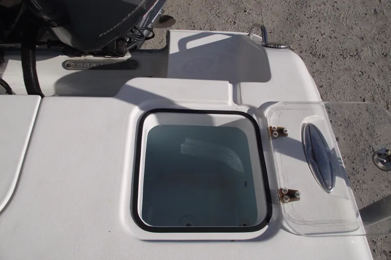 Slide: The Image of 2014 Sea Hunt Gamefish 25 boat hatch with open lid, showcasing sleek design. - 33