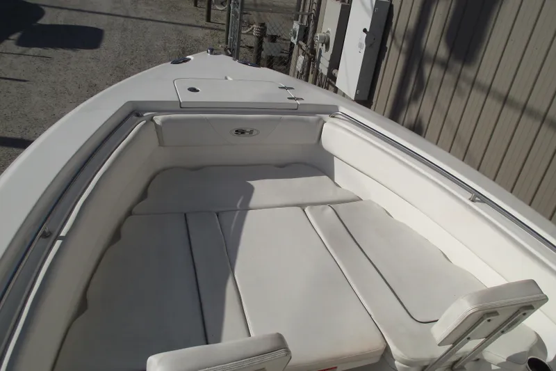 Slide: The Image of 2014 Sea Hunt Gamefish 25 boat interior with white cushioned seating. - 6