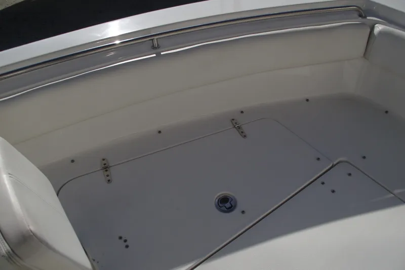 Slide: The Image of 2014 Sea Hunt Gamefish 25 boat interior with storage compartment and stainless steel railing. - 9